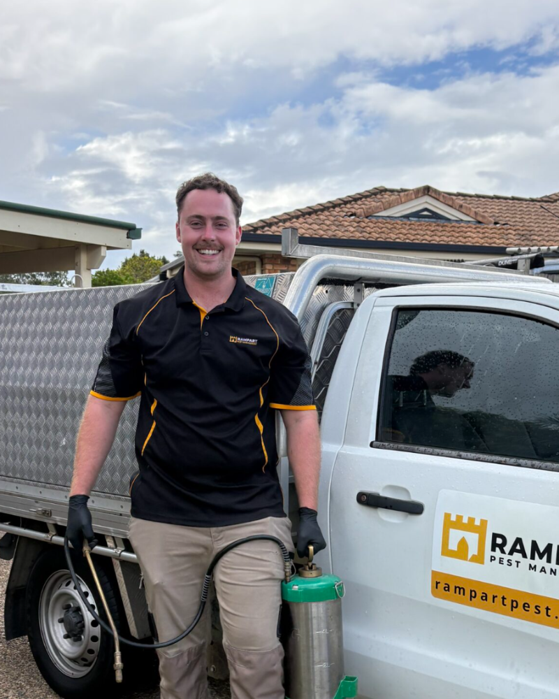 Rampart Pest Management owner beside the branded work truck